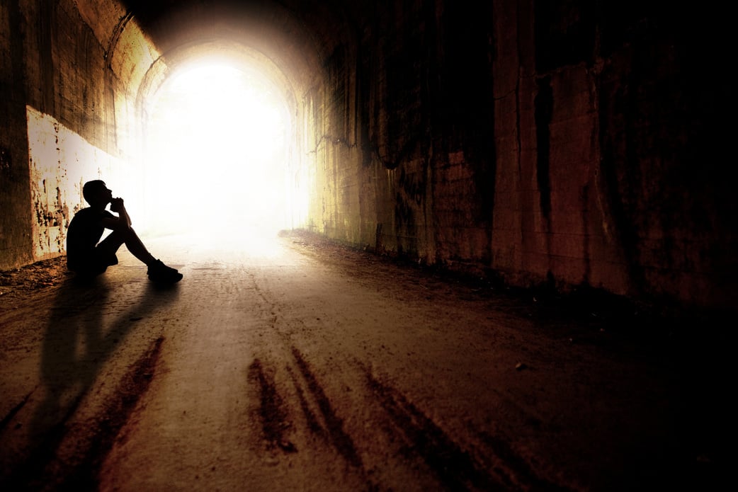 Silhouette of  Teen in Praying in Dark Tunnel